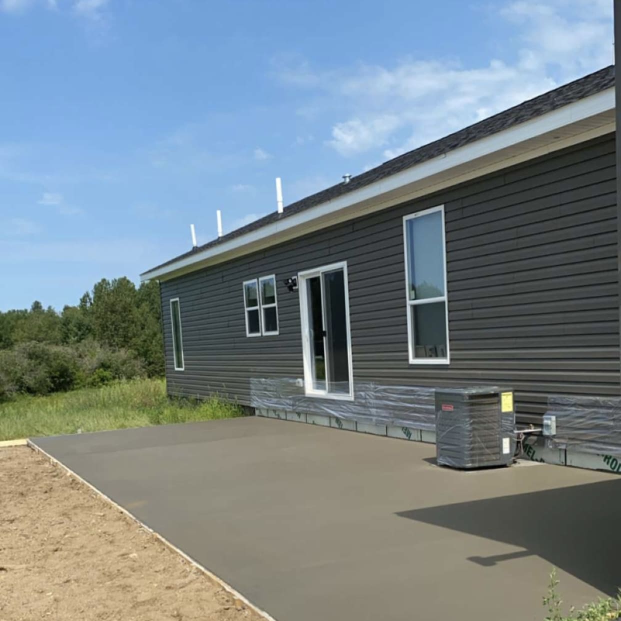 Concrete patio behind a house.